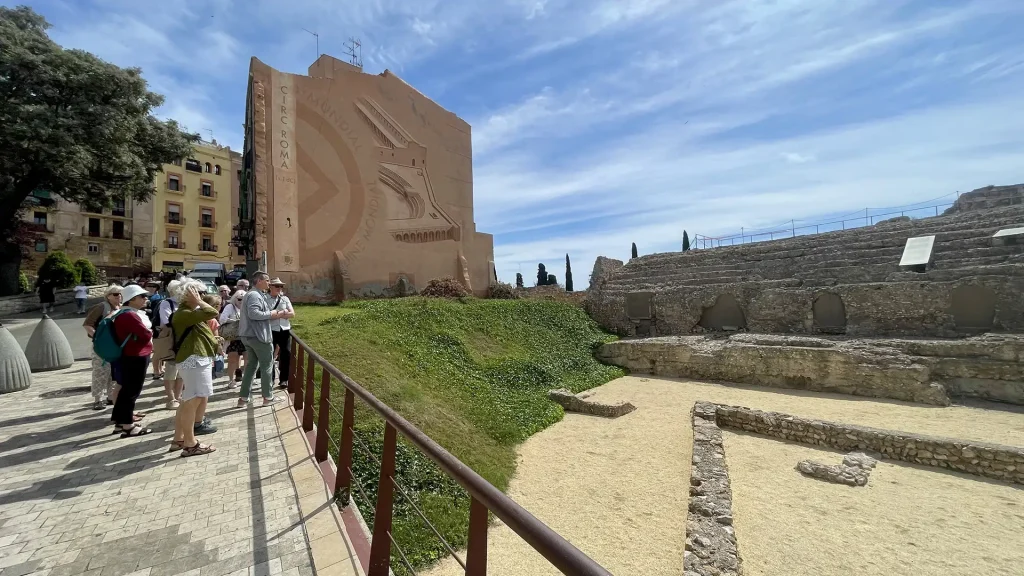 a walking group walking through the roman circus in tarragona