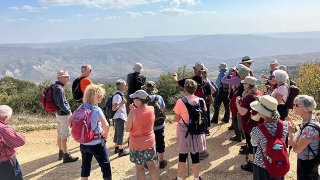 a group of walkers listening to the local walking guide